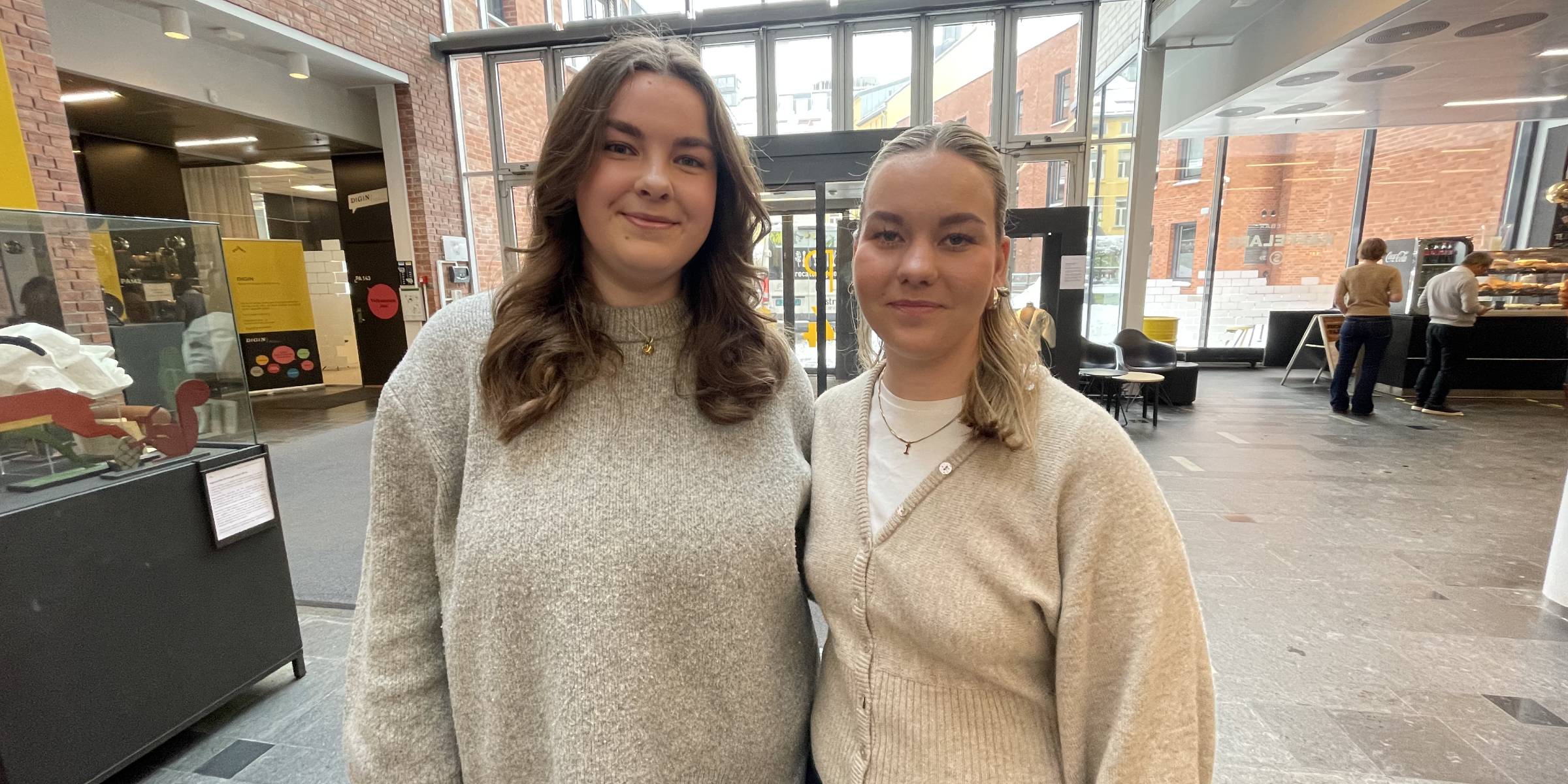 Occupational therapy students Kine Marie Kvaal and Iris Sakshaug smile for the camera in the foyer at Pilestredet 46 at OsloMet