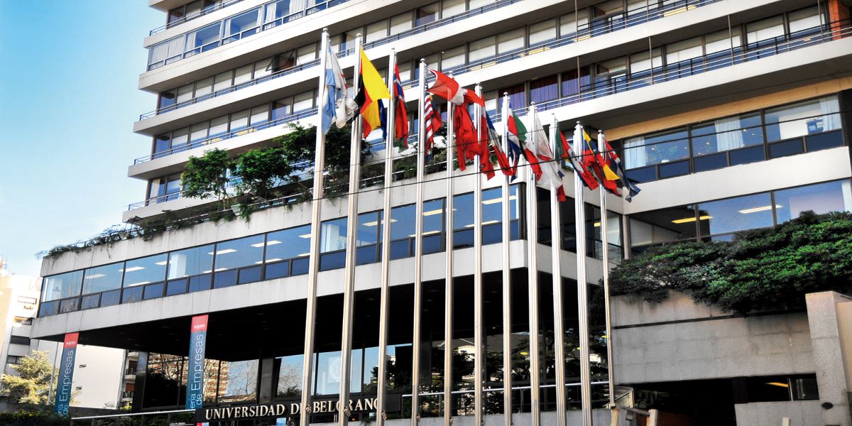 The main entrance of the university with international flags in front